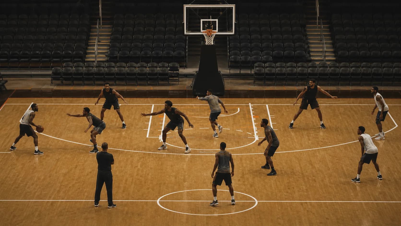 Five defenders shifting together in shell position during a half-court practice